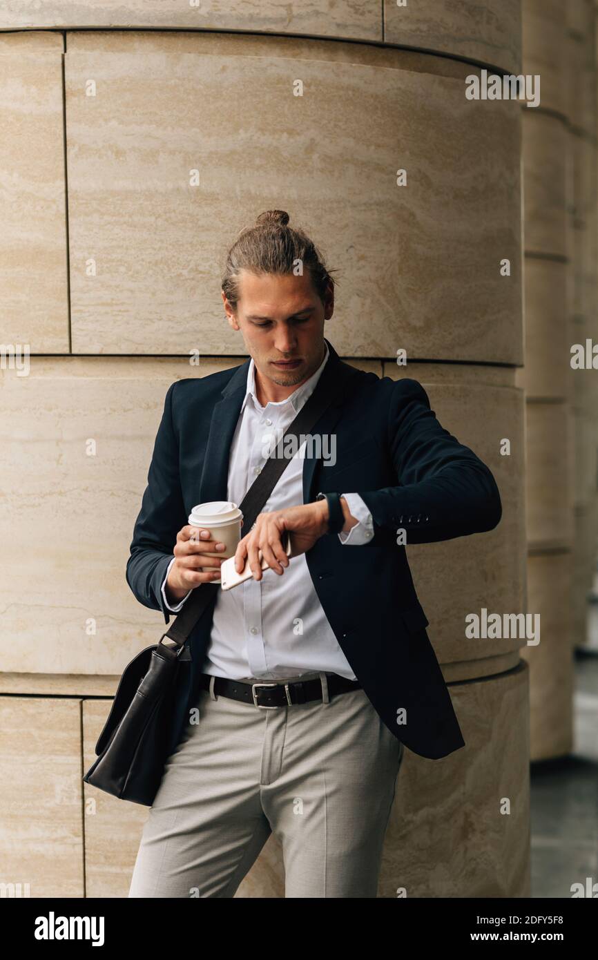 Young entrepreneur in formal wear holding a coffee Stock Photo