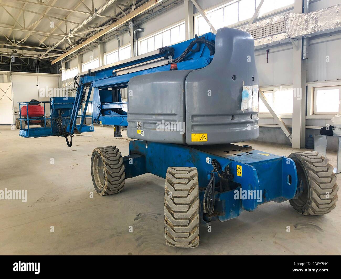 Lifting vehicle platform works inside industrial building Stock Photo