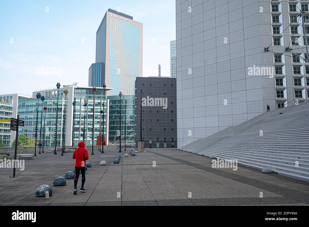 Jogger in the business district La Defense in Paris, France. Modern skyscrapers on the background Stock Photo