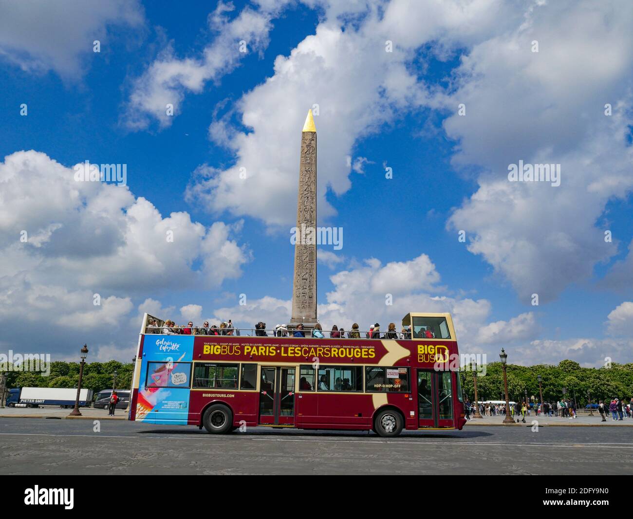 Red, double deck tour bus paces Oblisque i Place de la Concorde in Paris, France on a sunny spring day Stock Photo