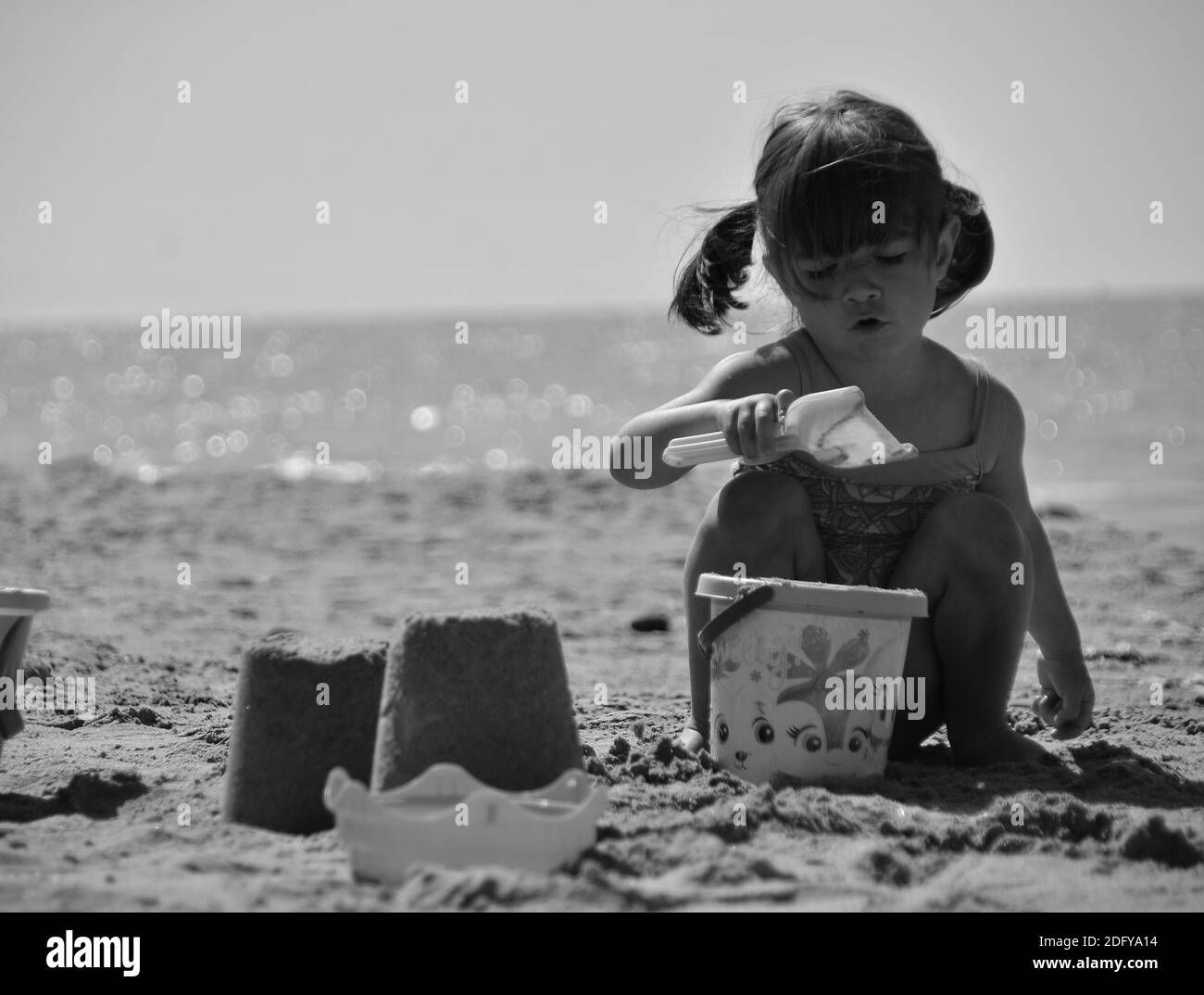 Little girl playing on beach Black and White Stock Photos & Images - Alamy