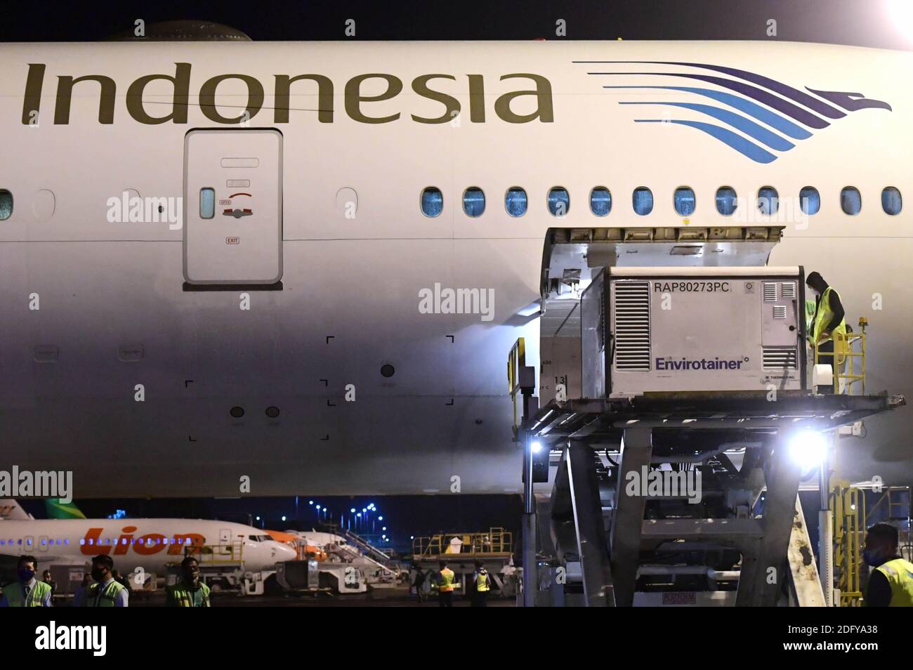 (201207) -- JAKARTA, Dec. 7, 2020 (Xinhua) -- Workers unload vaccine supplies from China's Sinovac at the Soekarno-Hatta International Airport in Tangerang district of Banten Province in Indonesia, Dec. 6, 2020. COVID-19 vaccines from China were in good condition upon arrival in Indonesia and refrigeration vehicles for delivery have been well prepared to keep the vaccines undamaged and safe, Health Minister Terawan Agus Putranto said on Monday. A vaccine storage warehouse has also been prepared to accommodate 1.2 million doses of the Sinovac vaccine from China with cold chain management fo Stock Photo