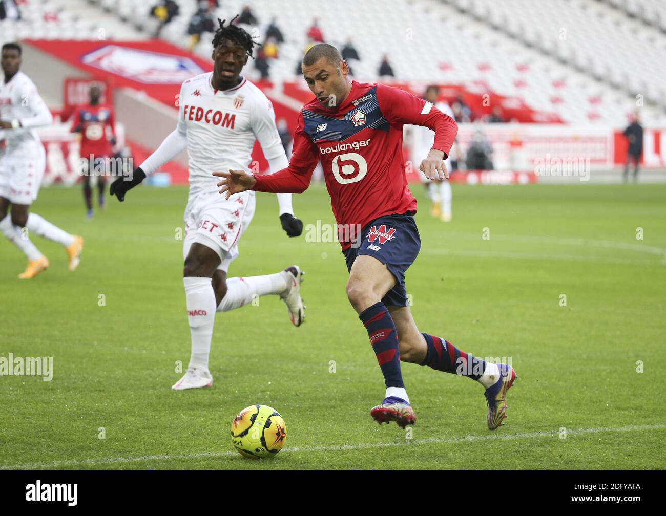 Burak Yilmaz of Lille, Axel Disasi of Monaco (left) during the French championship Ligue 1 football match between Lille OSC and  / LM Stock Photo