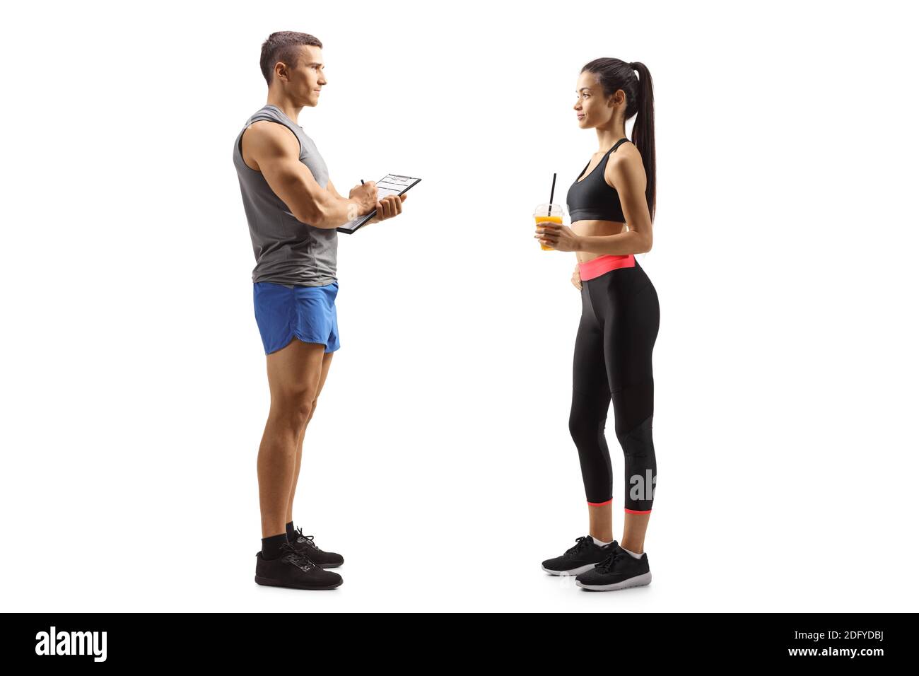 Personal trainer and a young female in sportswear isolated on white background Stock Photo