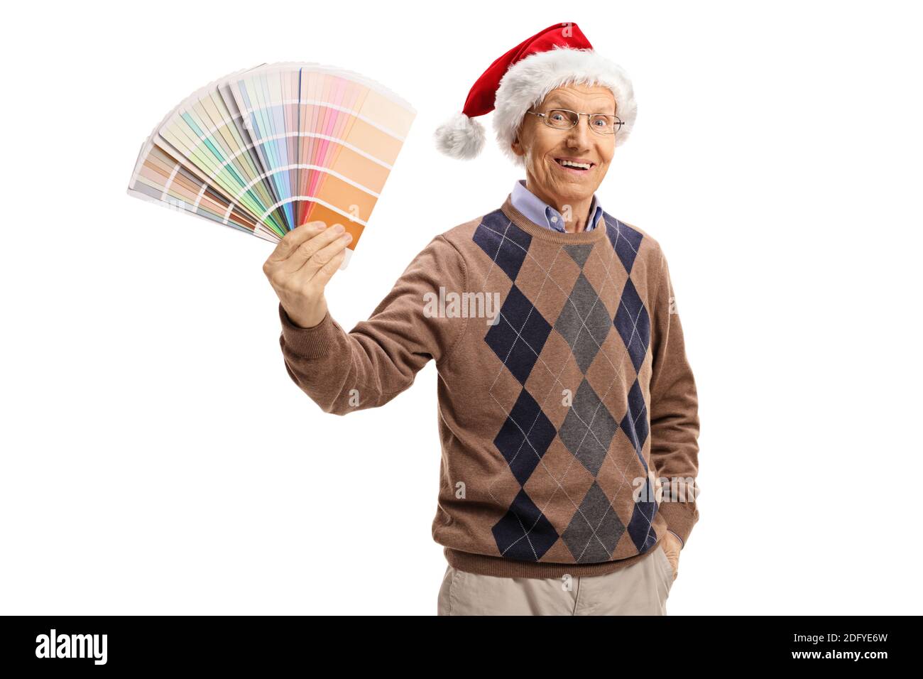 Elderly man with a santa claus hat holding a color swatch and looking at the camera isolated on white background Stock Photo
