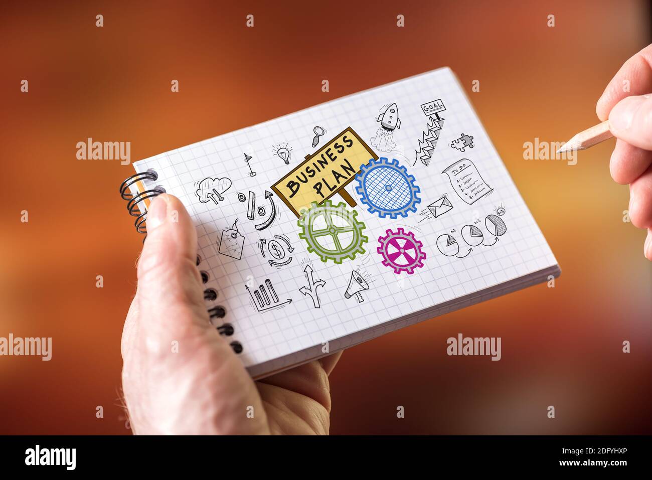 Hand drawing business plan concept on a notepad Stock Photo - Alamy