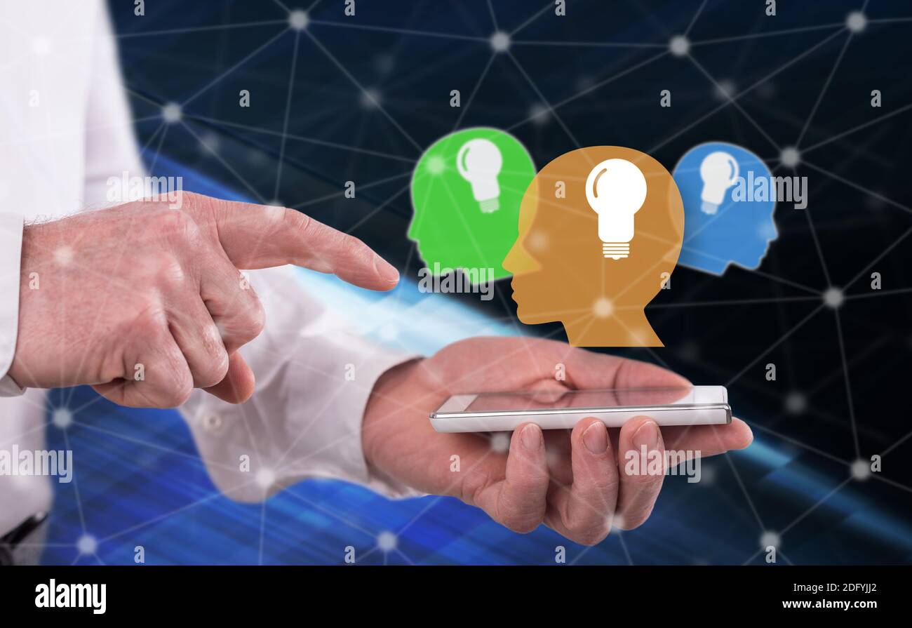 Human brain ideas concept above a smartphone held by a man Stock Photo ...