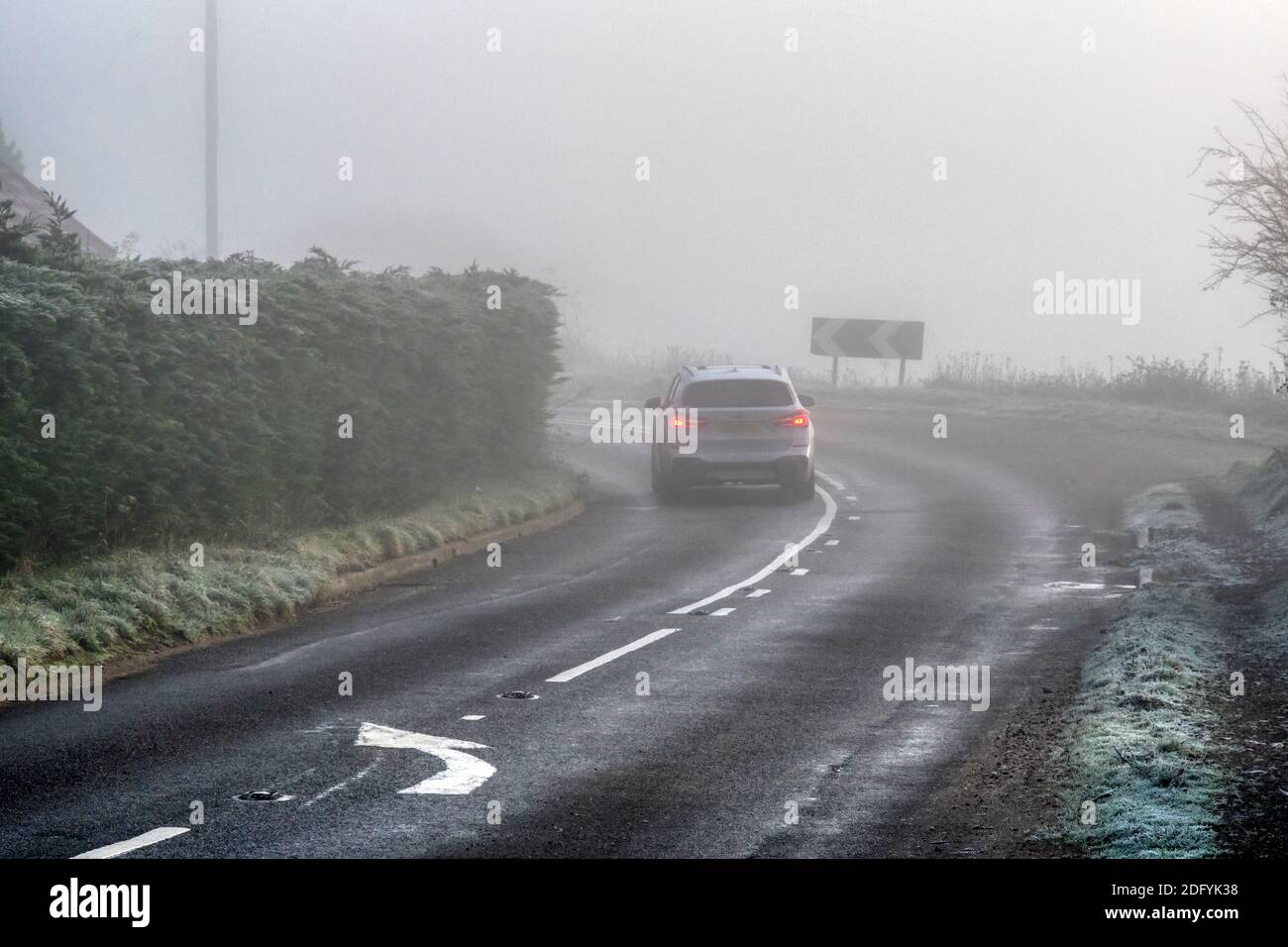 A car on a country road in freezing fog during winter Stock Photo Alamy