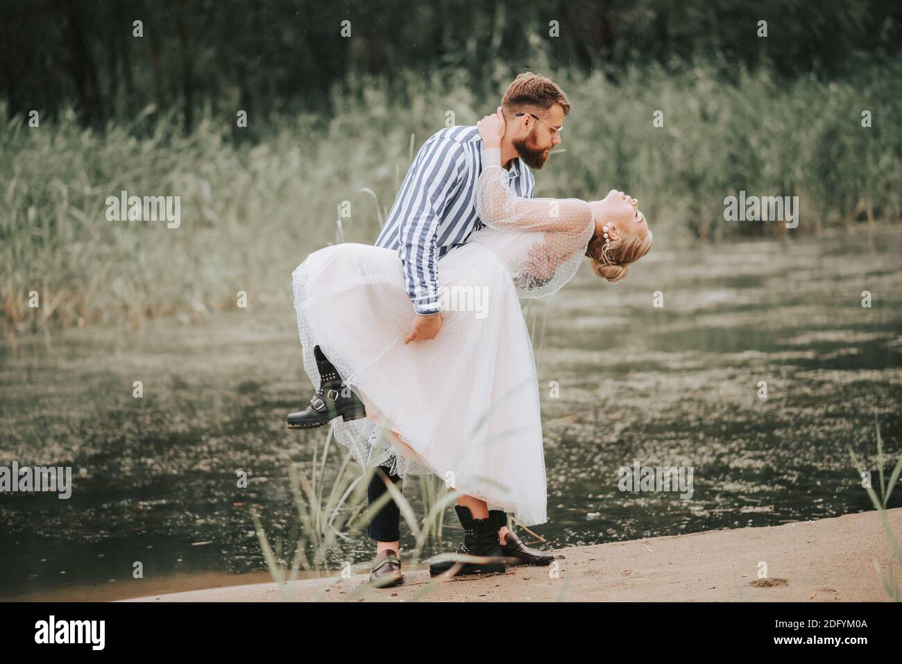 Young couple embracing passionately on a remote beach Stock Photo - Alamy