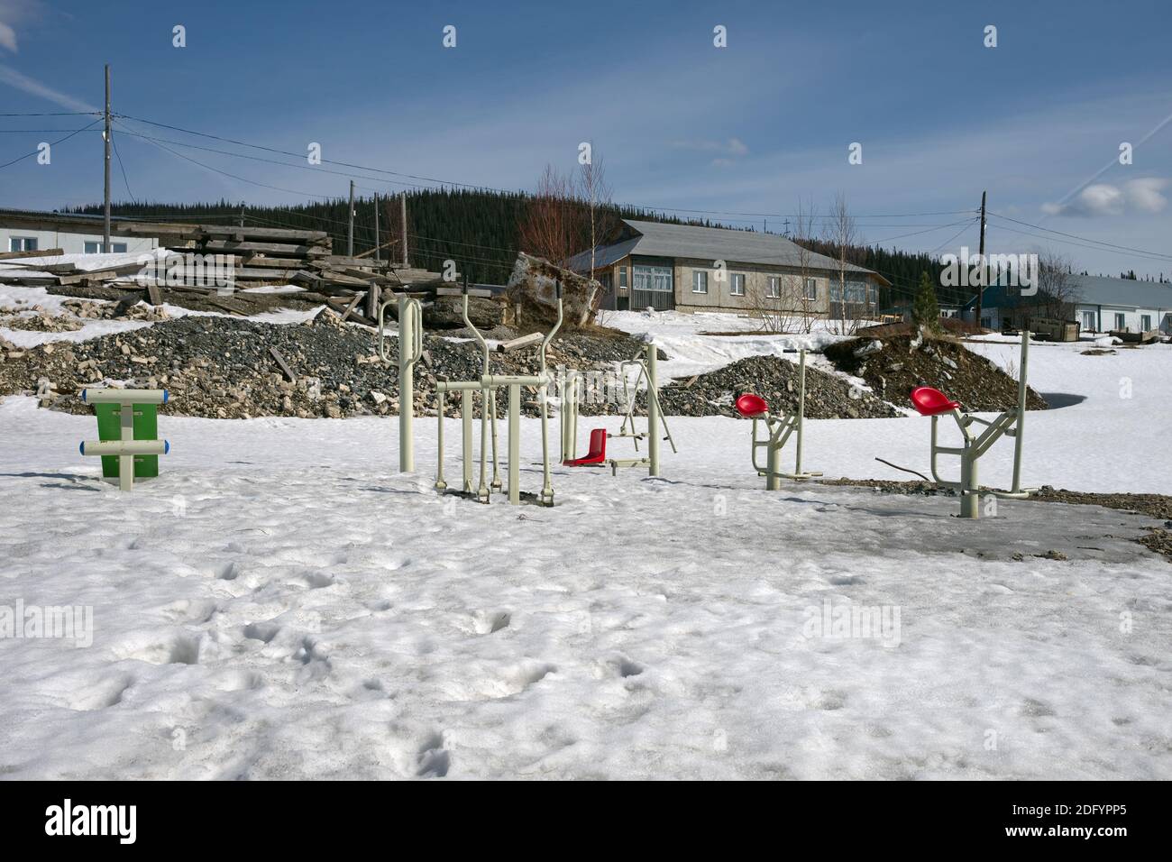 Sports simulators thaw out from under the snow in a village street in the spring. Stock Photo
