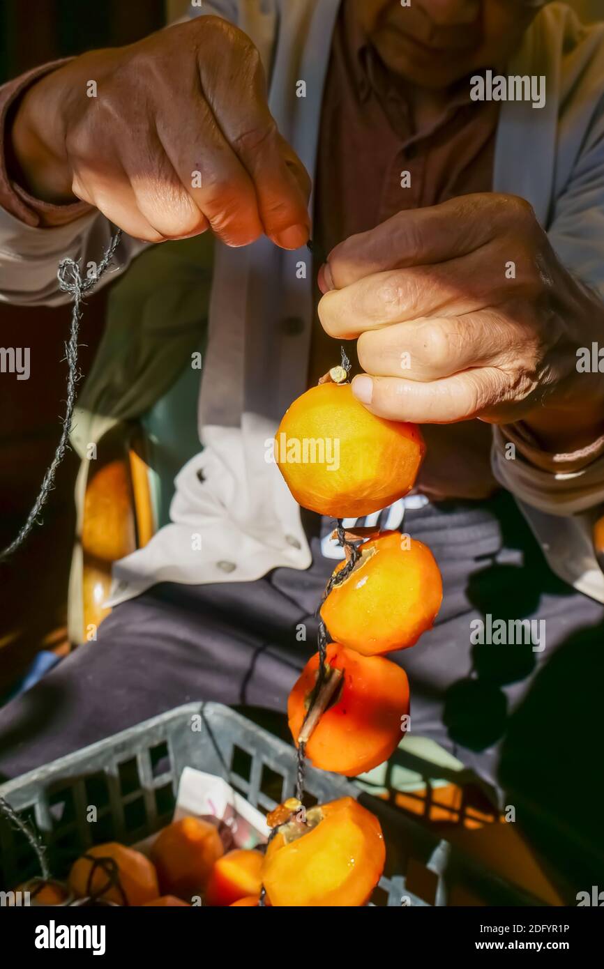 Man drying persimmon hires stock photography and images Alamy