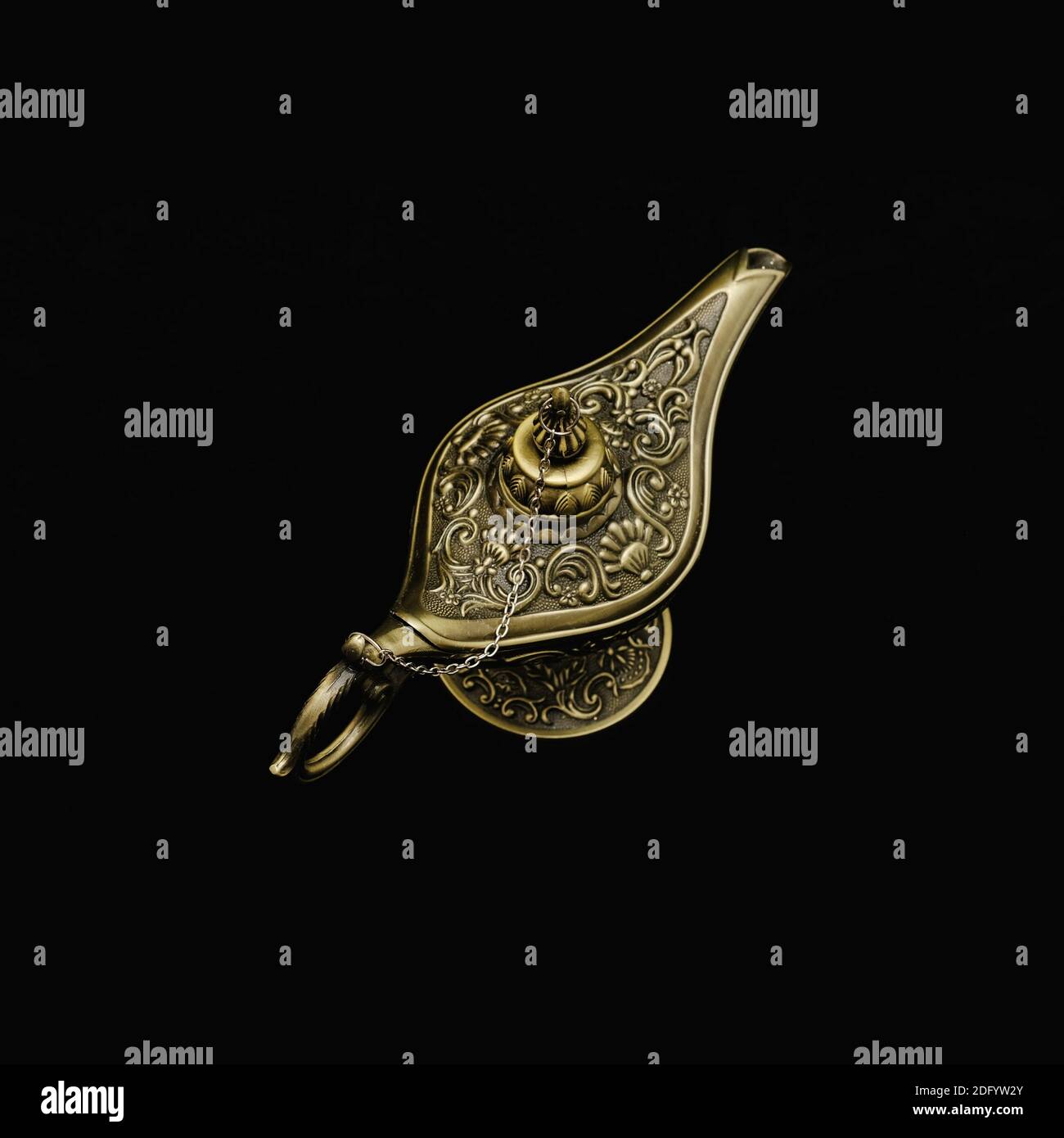 Vintage Ornate Ancient Aladdin Lamp on black background. Magical Mysterious Genie Lamp of Desire. Abracadabra spell.  Stock Photo