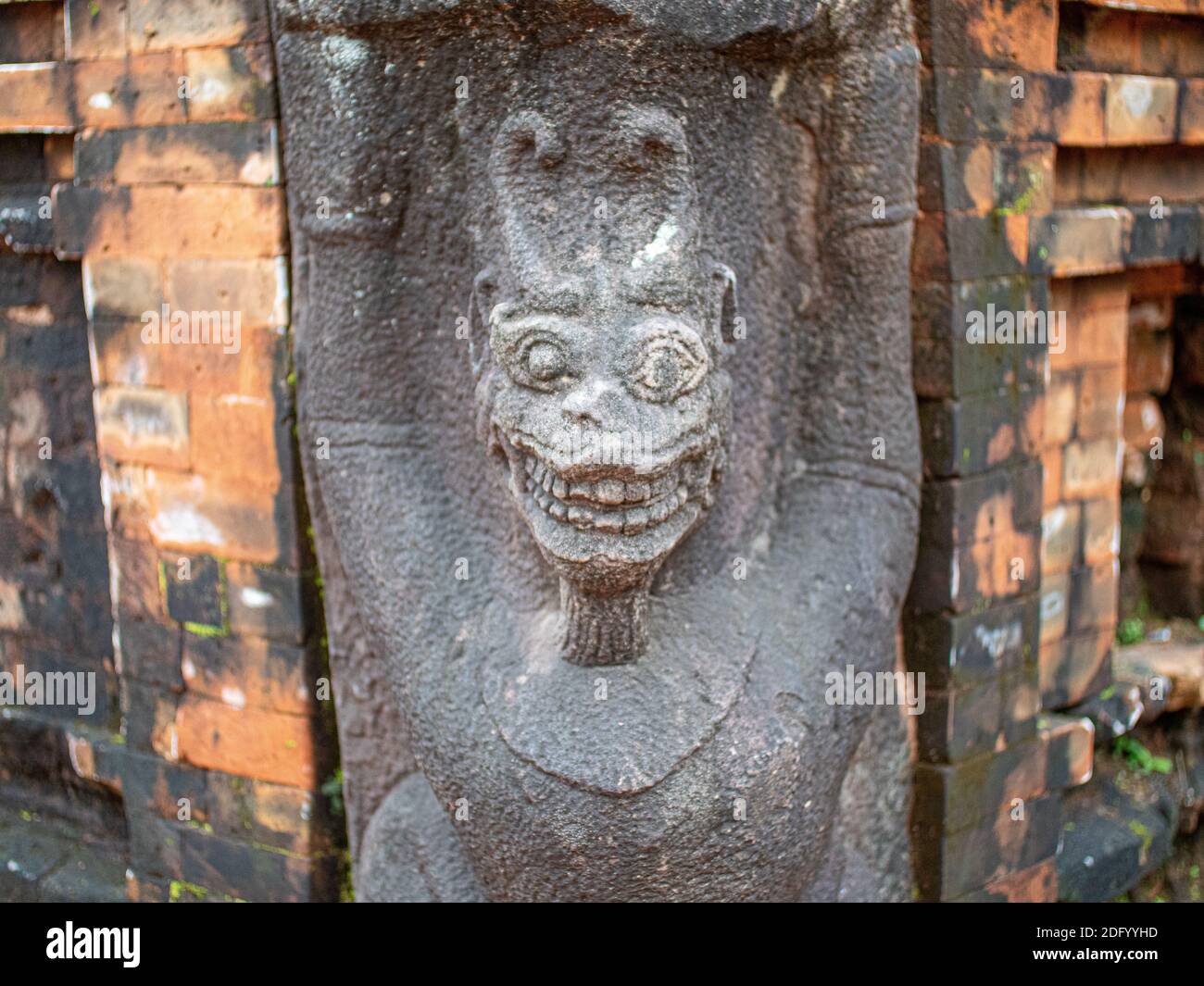 A stone statue of a demon-like deity on the wall of a temple at Preah Ko Temple, Angkor Wat, Cambodia Stock Photo