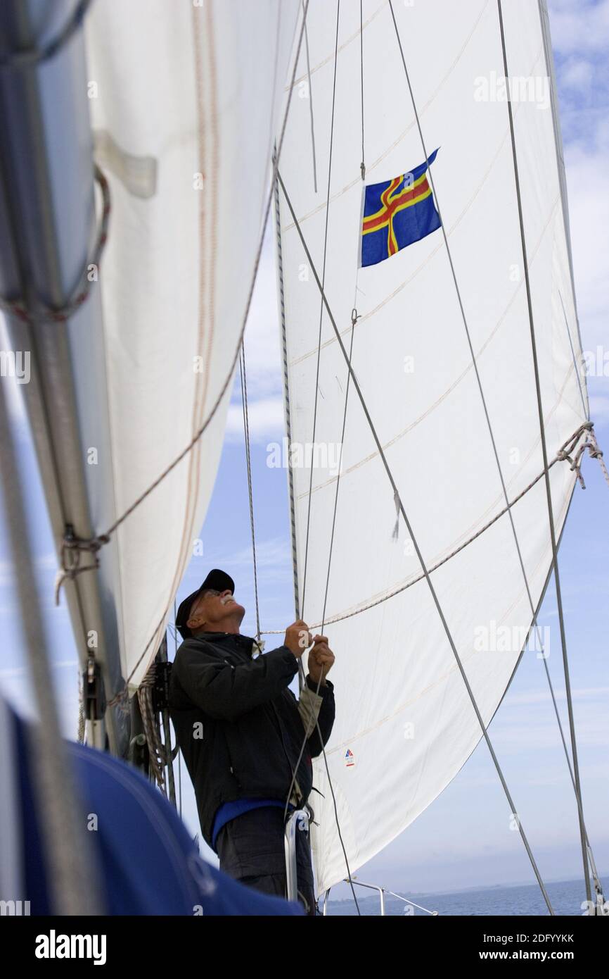 Lifting a courtesy flag on a sailboat Stock Photo Alamy