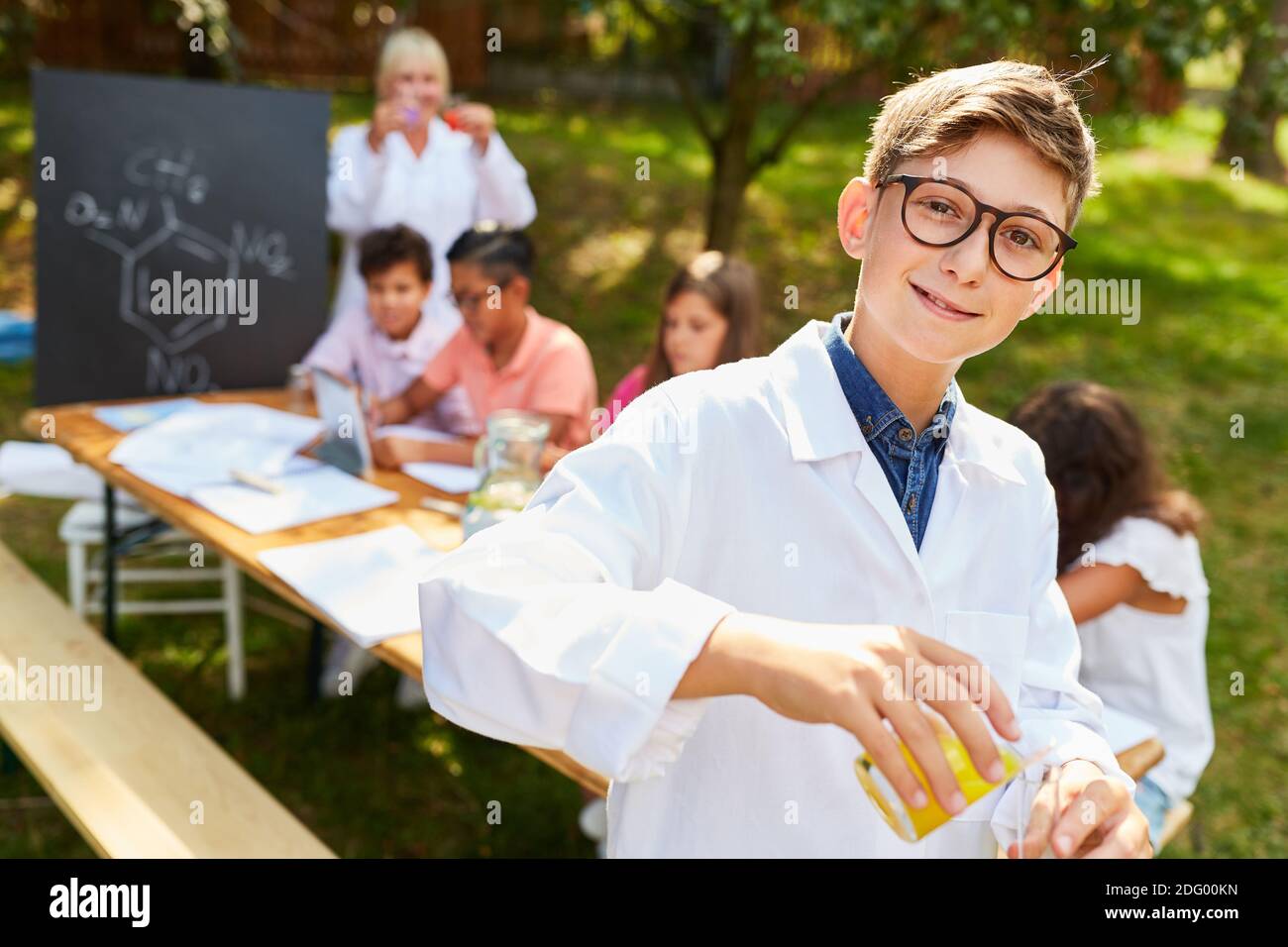 Happy boy in summer school chemistry tutoring course Stock Photo