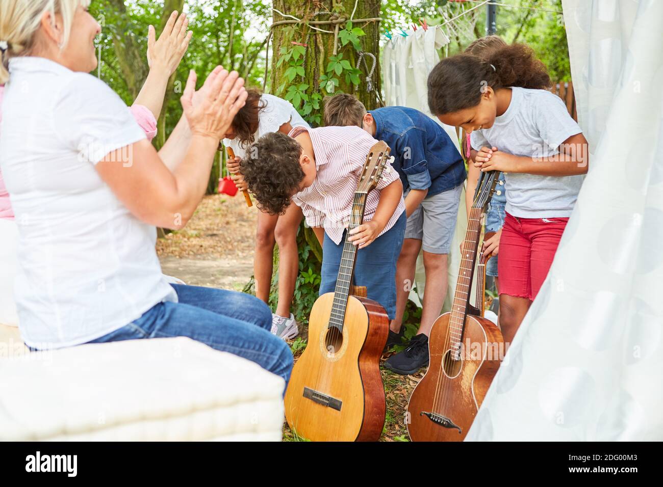 Children bow after the concert appearance on the talent show at the summer camp Stock Photo