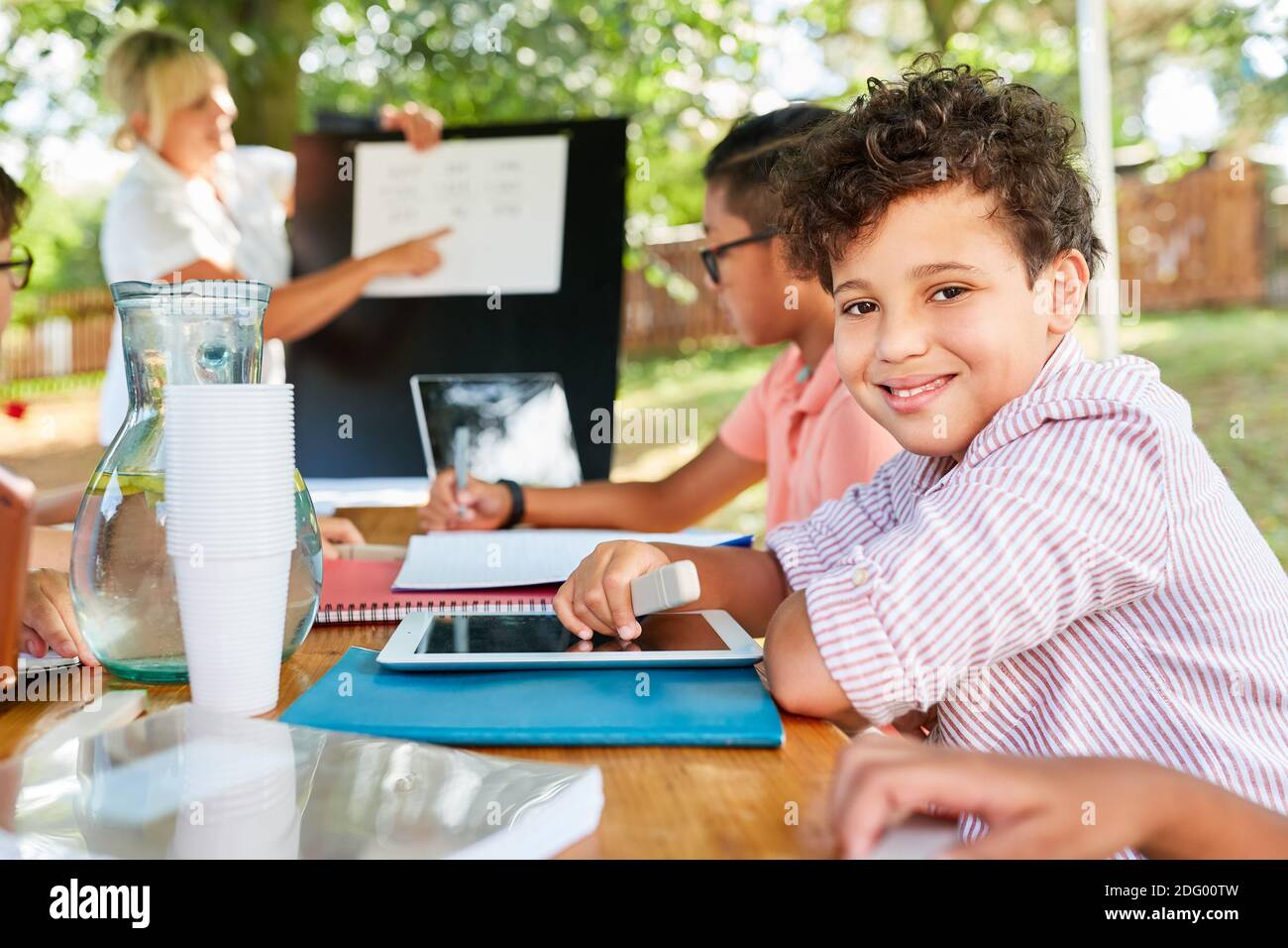 Happy group of children at tutoring class in summer school vacation course Stock Photo