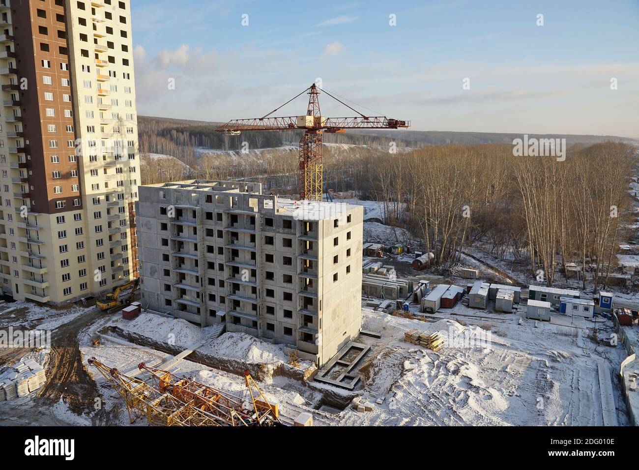 Construction site with crane and under construction highrise apartment