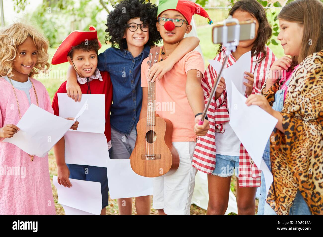 Group of kids in funny disguise takes a selfie after the summer camp talent  show Stock Photo - Alamy