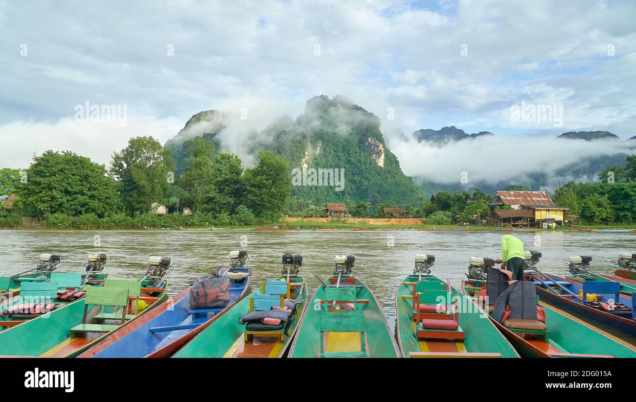 Boats Park in the Riverside Waiting the Tourists for Sightseeing in Nam Song River, Vang Vieng, Laos Stock Photo