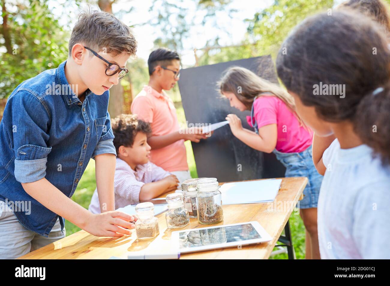 Group of children in summer school vacation course learns about environmental protection and biology Stock Photo