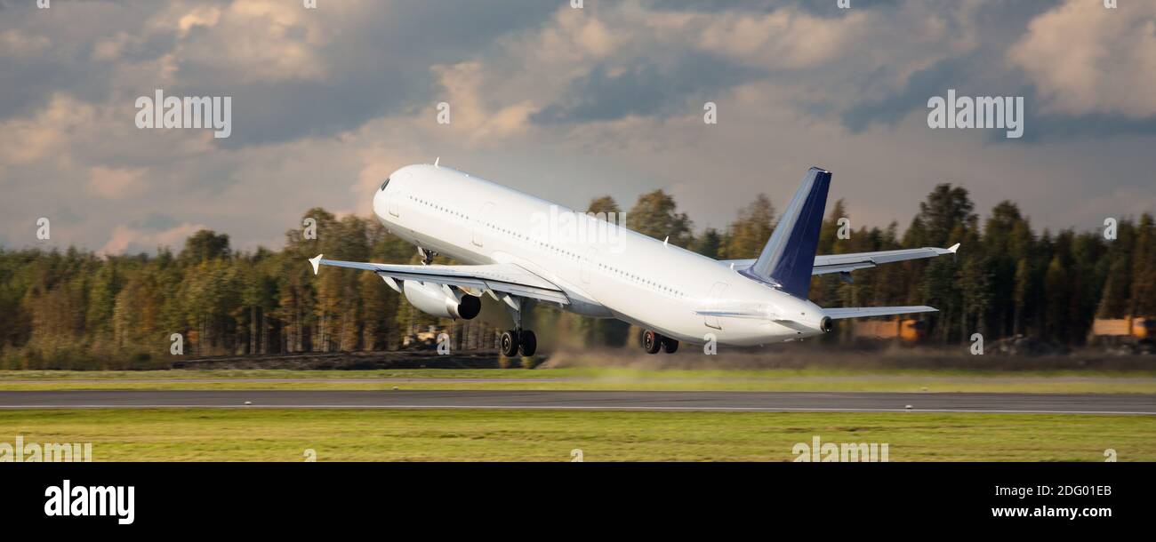 Airplane take off runway from airport at daytime, back view. Aviation, transportation, trip. Stock Photo