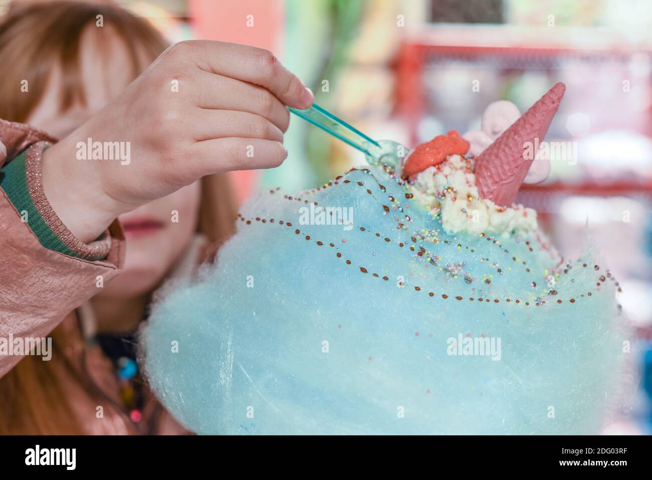 Sweets and candy on a huge cotton candy floss with ice cream and dessert sauce Stock Photo