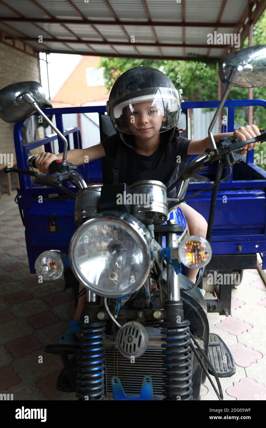 Portrait of a kid driving a tricycle Stock Photo Alamy