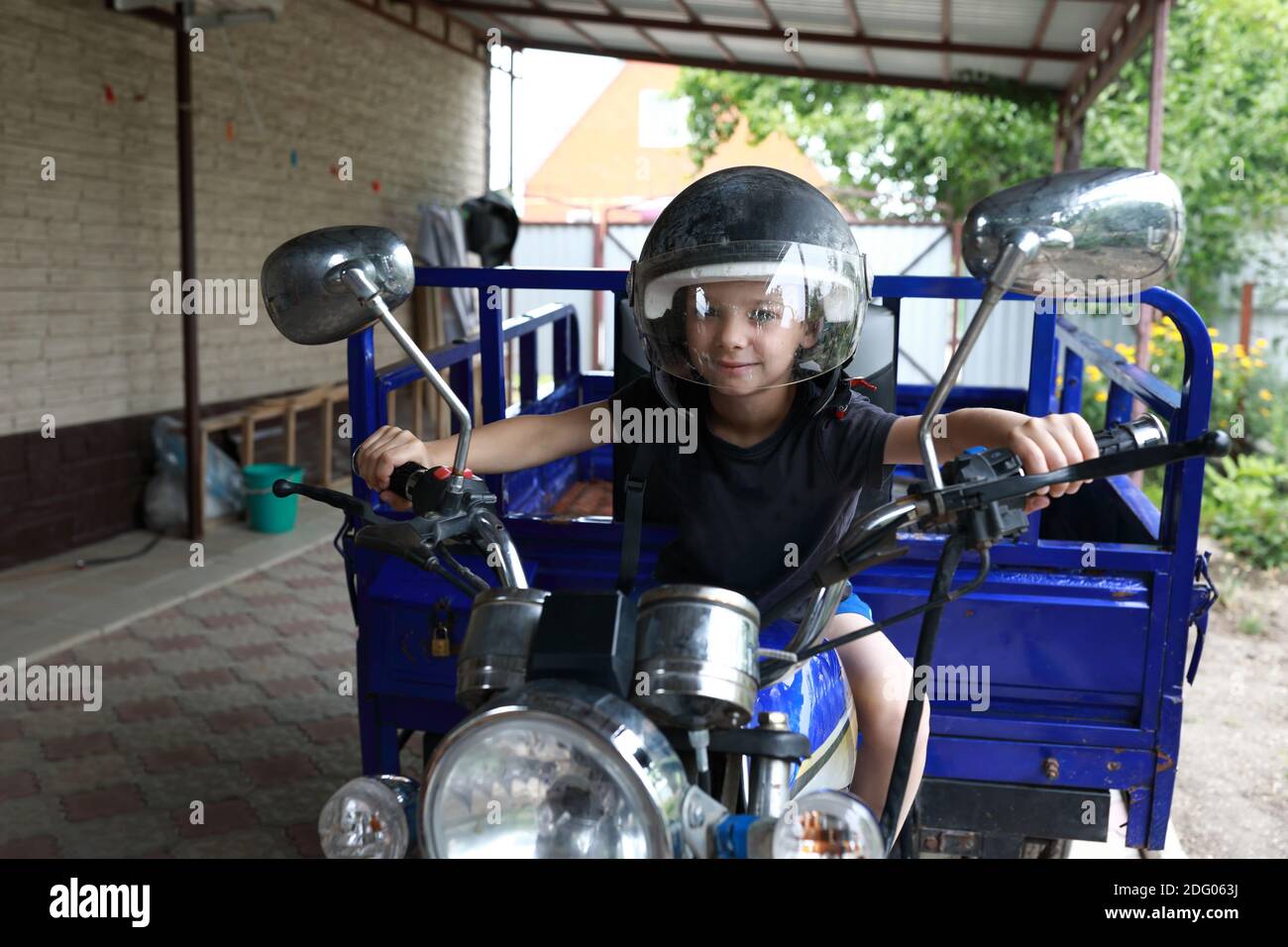 Portrait of a boy driving a tricycle Stock Photo Alamy