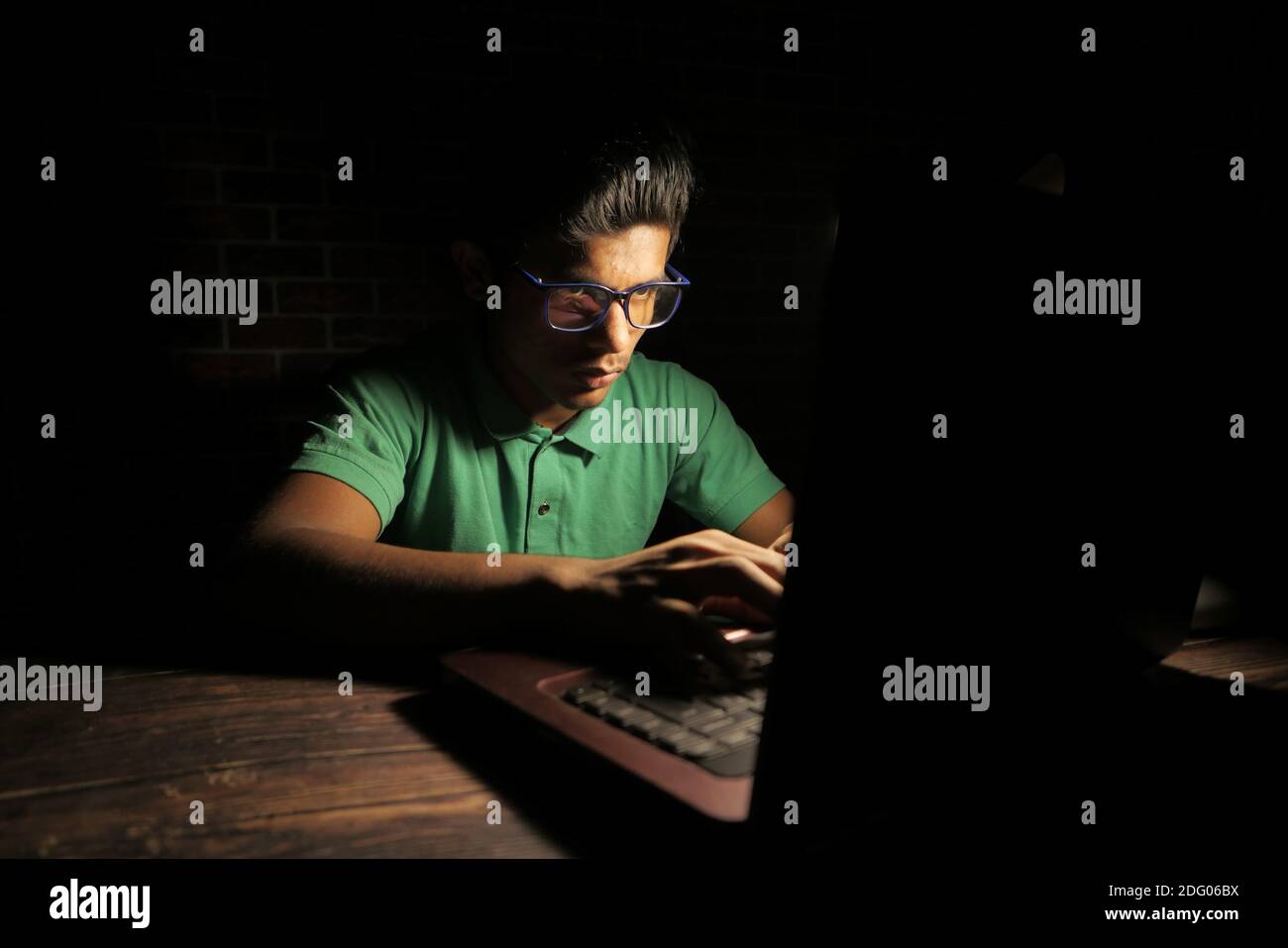young man working on laptop stealing personal data  Stock Photo