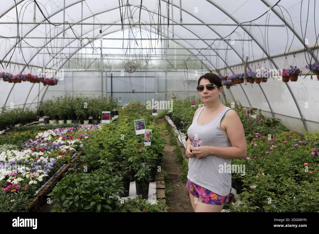 Portrait of woman in a greenhouse of flowers Stock Photo - Alamy