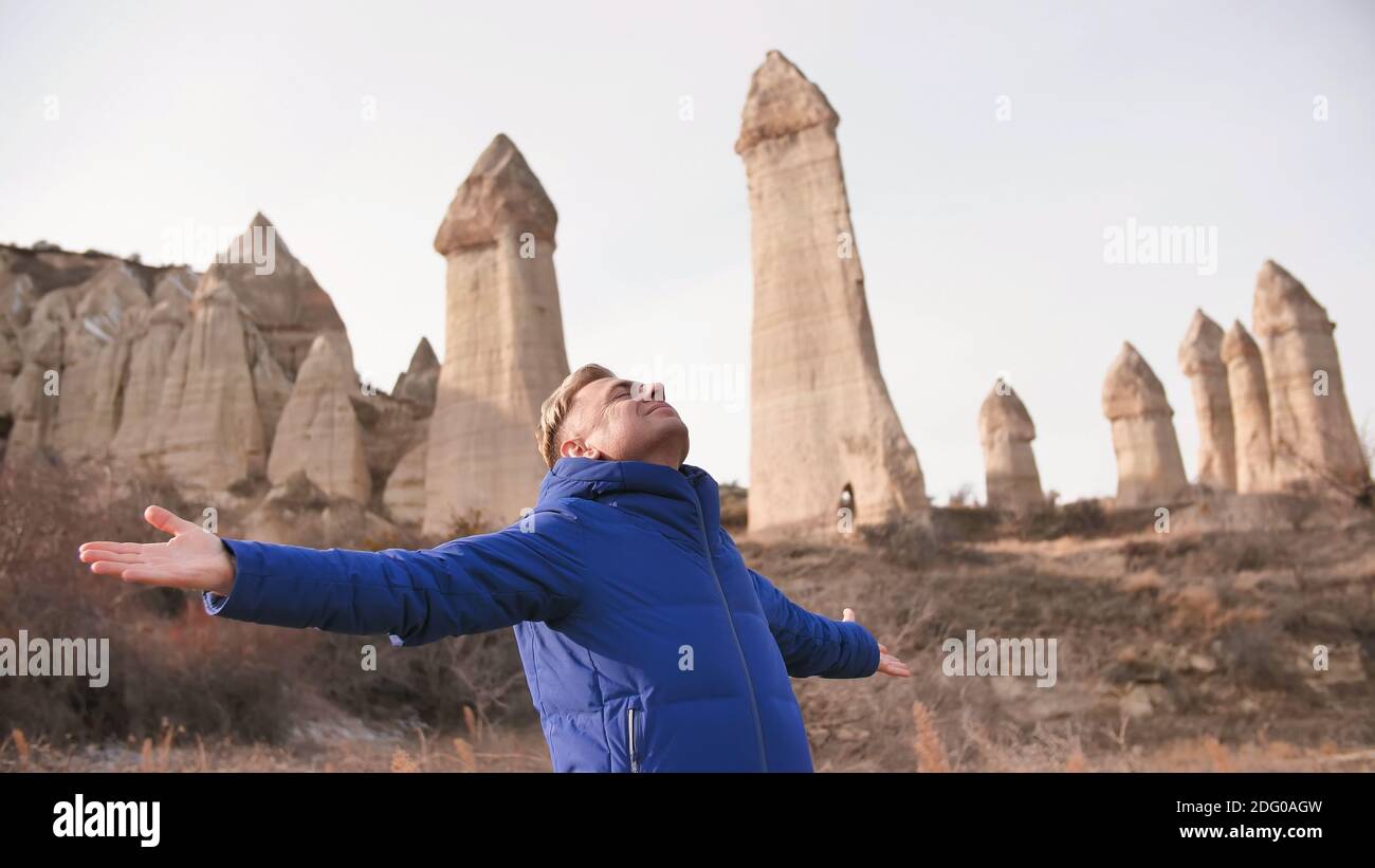 Russian tourist energized in the Valley of Love in Goreme Cappadocia Turkey during the freezing winter months. Stock Photo