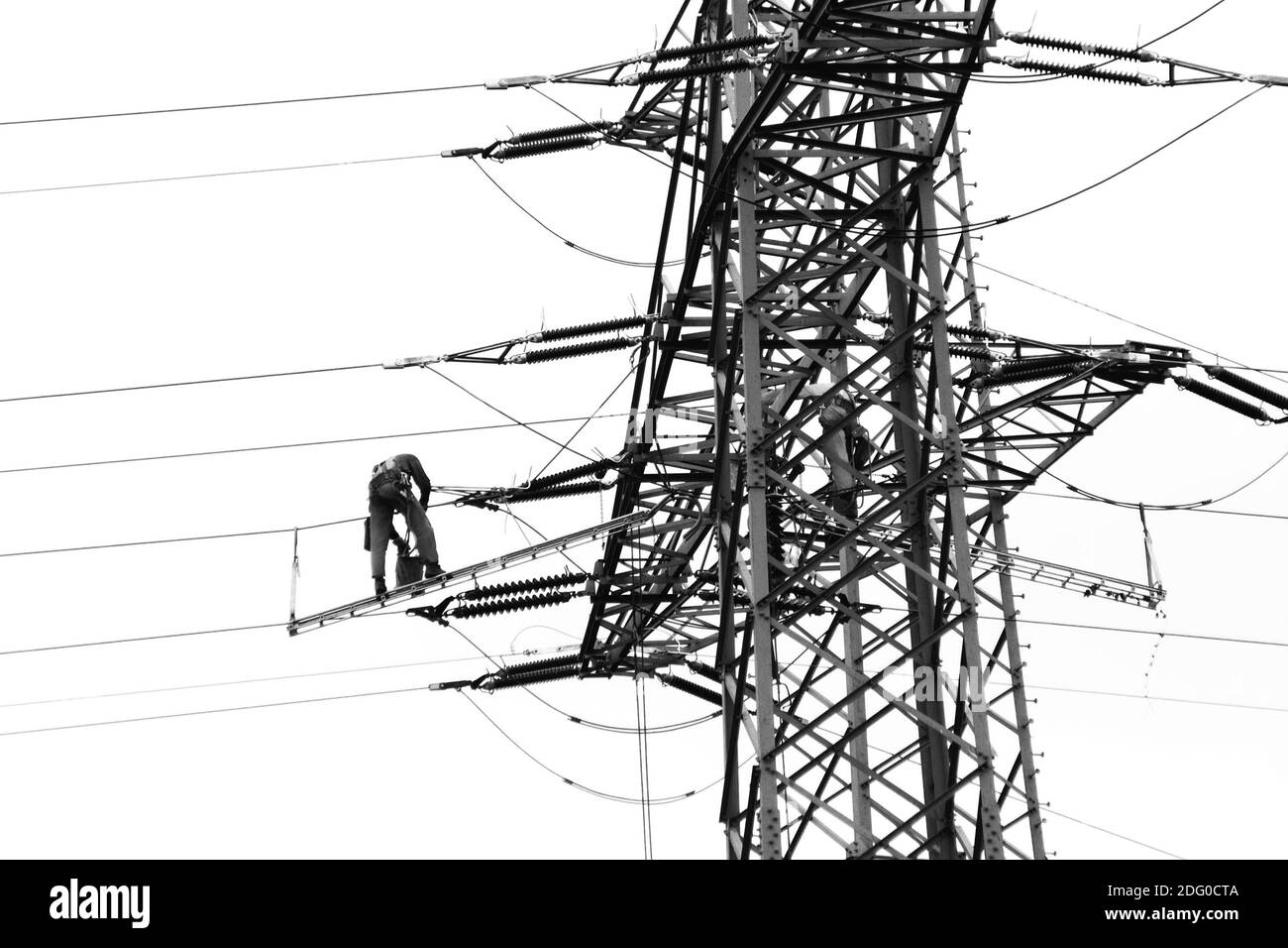 A worker on a high voltage pylon Stock Photo