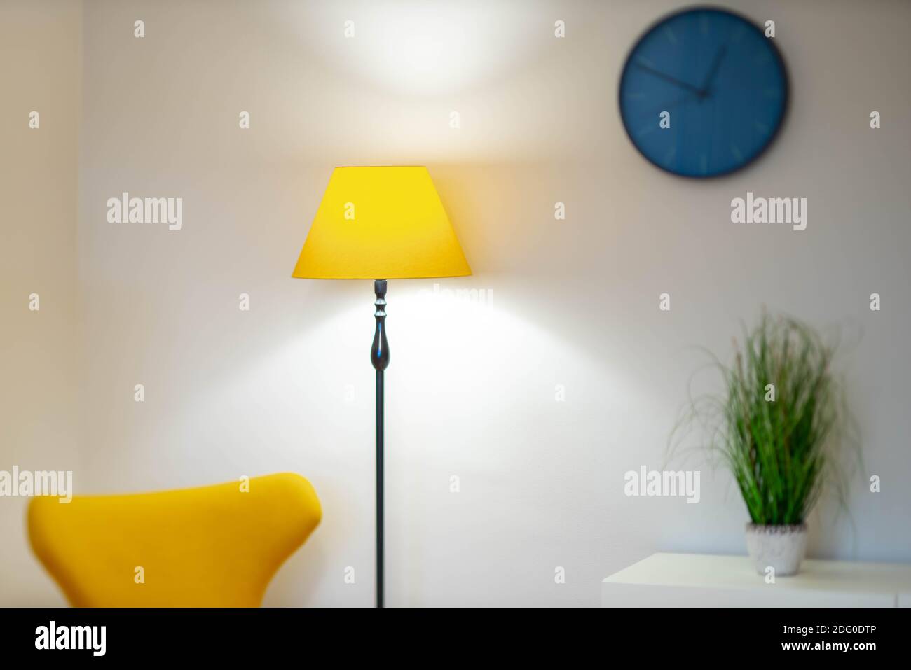 Modern interior of living room. Closeup of yellow floor lamp. White