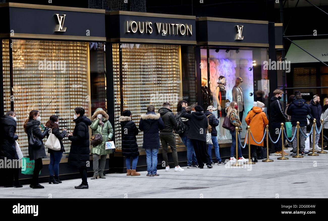 People queue outside a Louis Vuitton store amid the government reopening  bigger shops as well as small businesses in a loosening of the second  lockdown due to the coronavirus disease (COVID-19) outbreak,