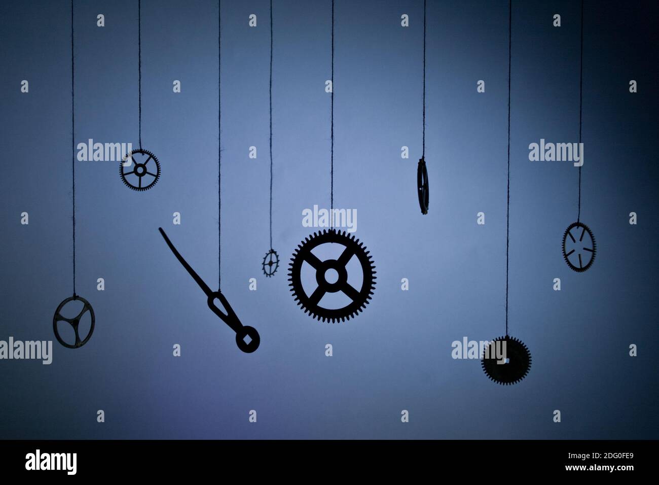 Gears hours suspended in space on a thread Stock Photo