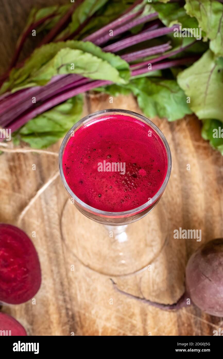 A glass of red beet juice with fresh root and leaves Stock Photo Alamy
