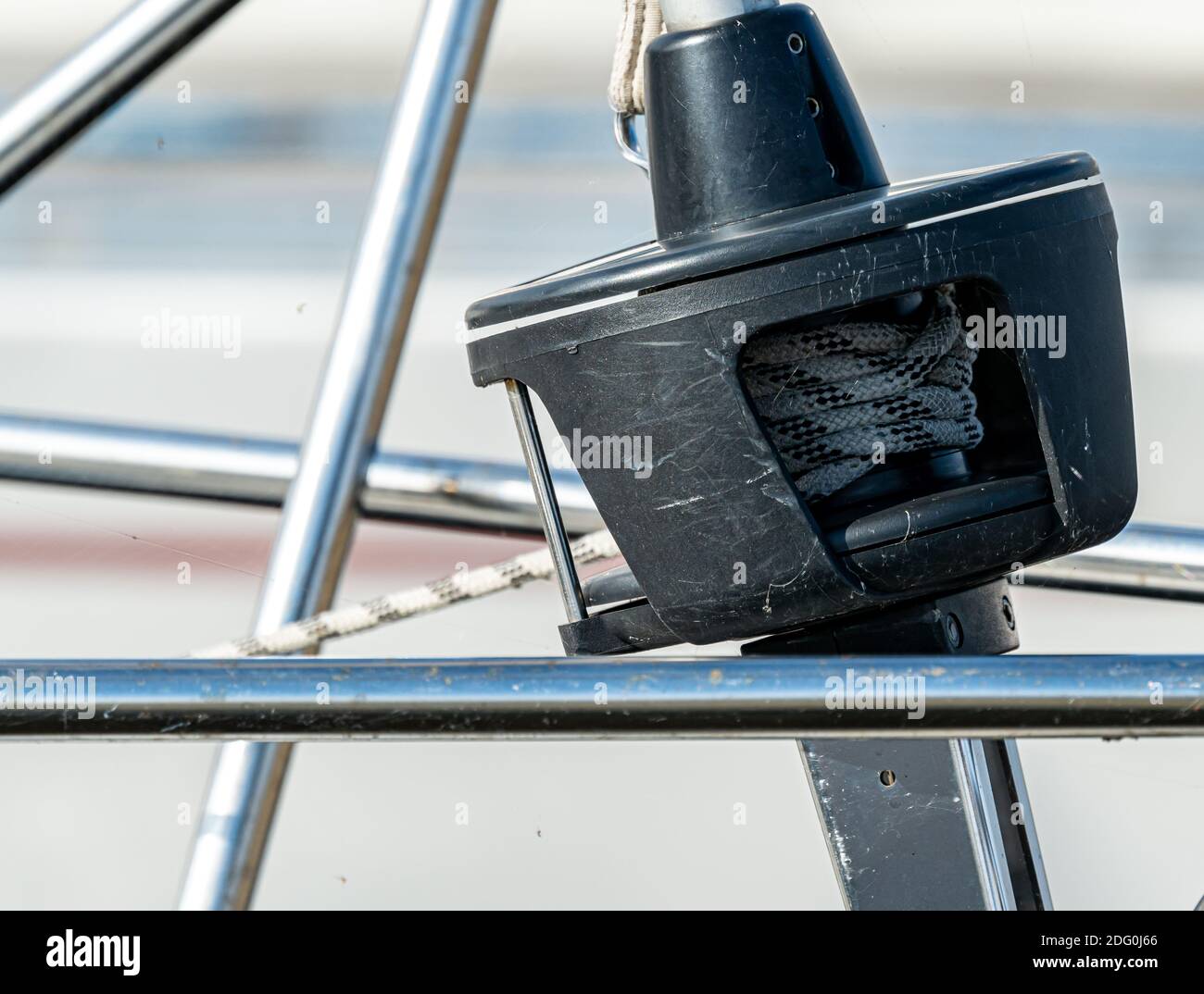 Roller furling on the bow of a sailboat to control the jib sail from the cockpit of the vessel. Close up.  Stock Photo