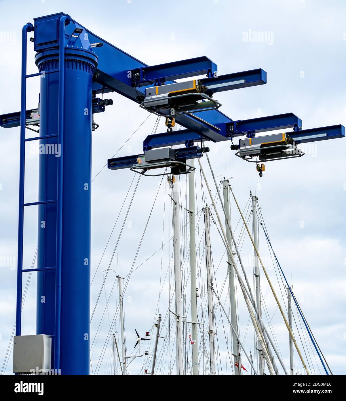 Blue heavy lift boat crane at the marina, ready to lift boats in and