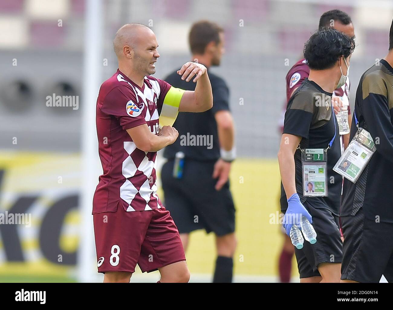 Doha, Qatar. 7th Dec, 2020. Andres Iniesta (L, front) of Vissel Kobe removes his armband during the round of 16 match of the AFC Champions League between Shanghai SIPG FC of China and Vissel Kobe of Japan in Doha, Qatar, Dec. 7, 2020. Credit: Nikku/Xinhua/Alamy Live News Stock Photo