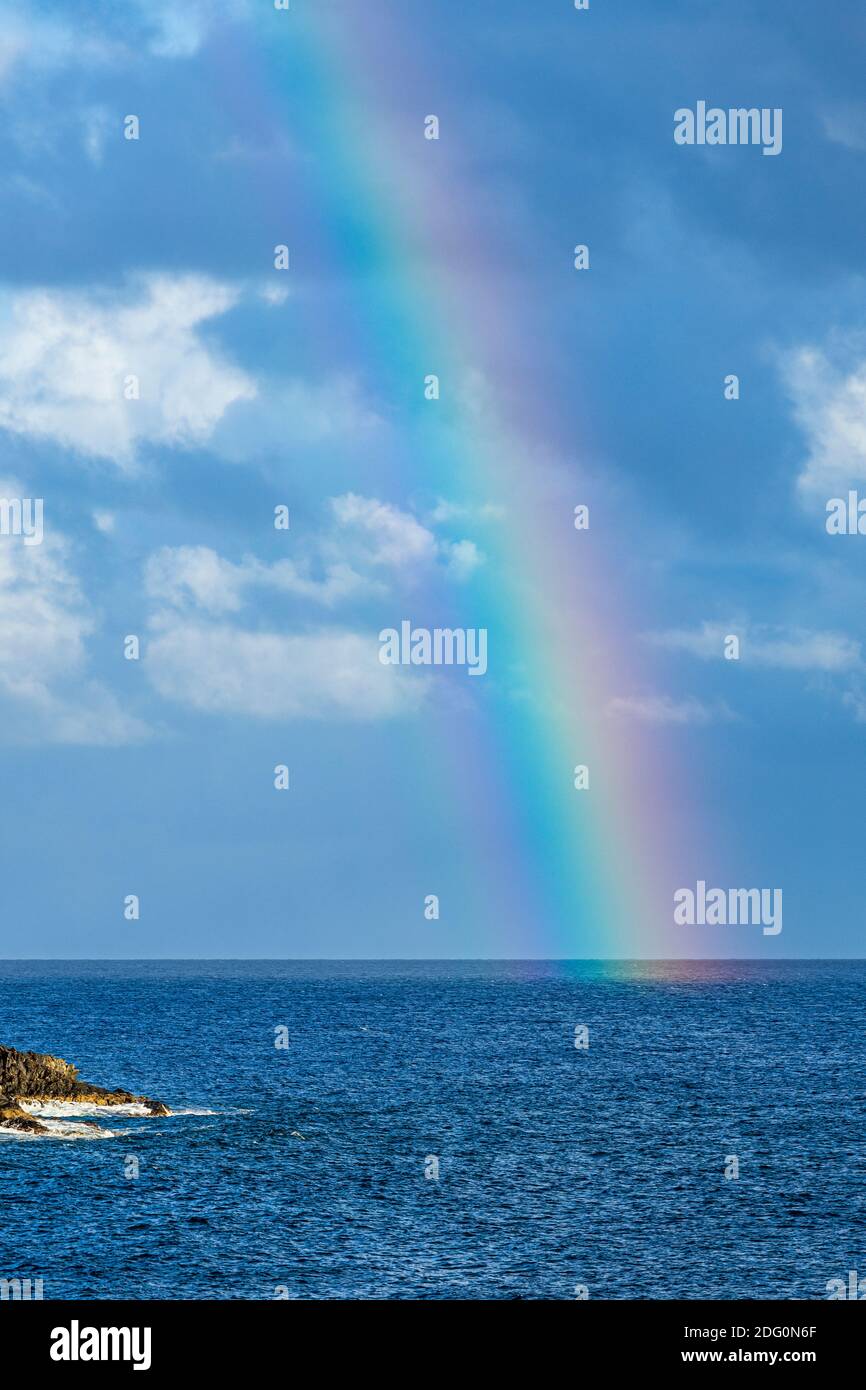 Rainbow over the sea offshore from yellow mountain, Montaña Amarilla, Costa Silencio, Tenerife, Canary Islands, Spain Stock Photo