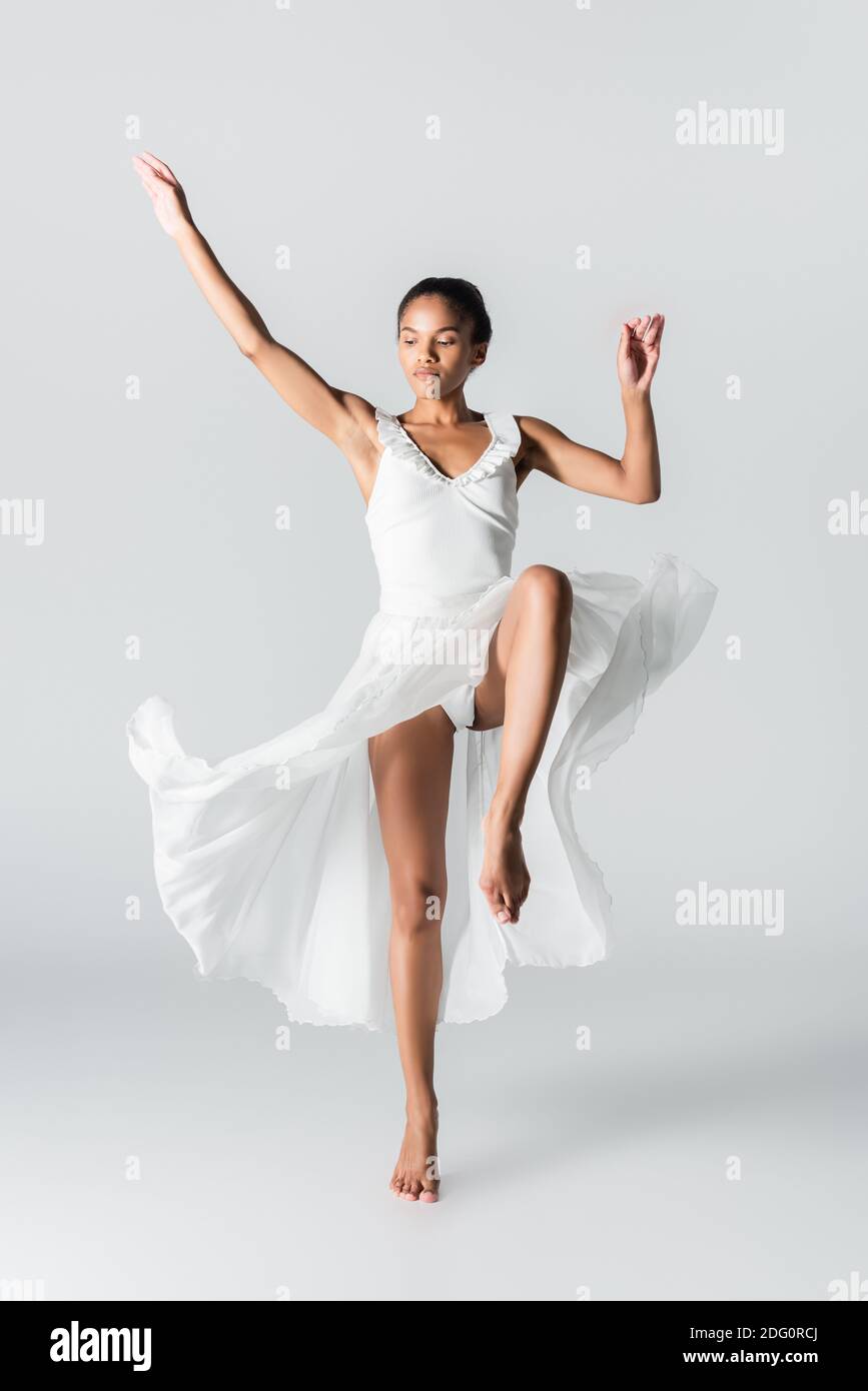 barefoot graceful african american ballerina in dress dancing on white background Stock Photo Alamy