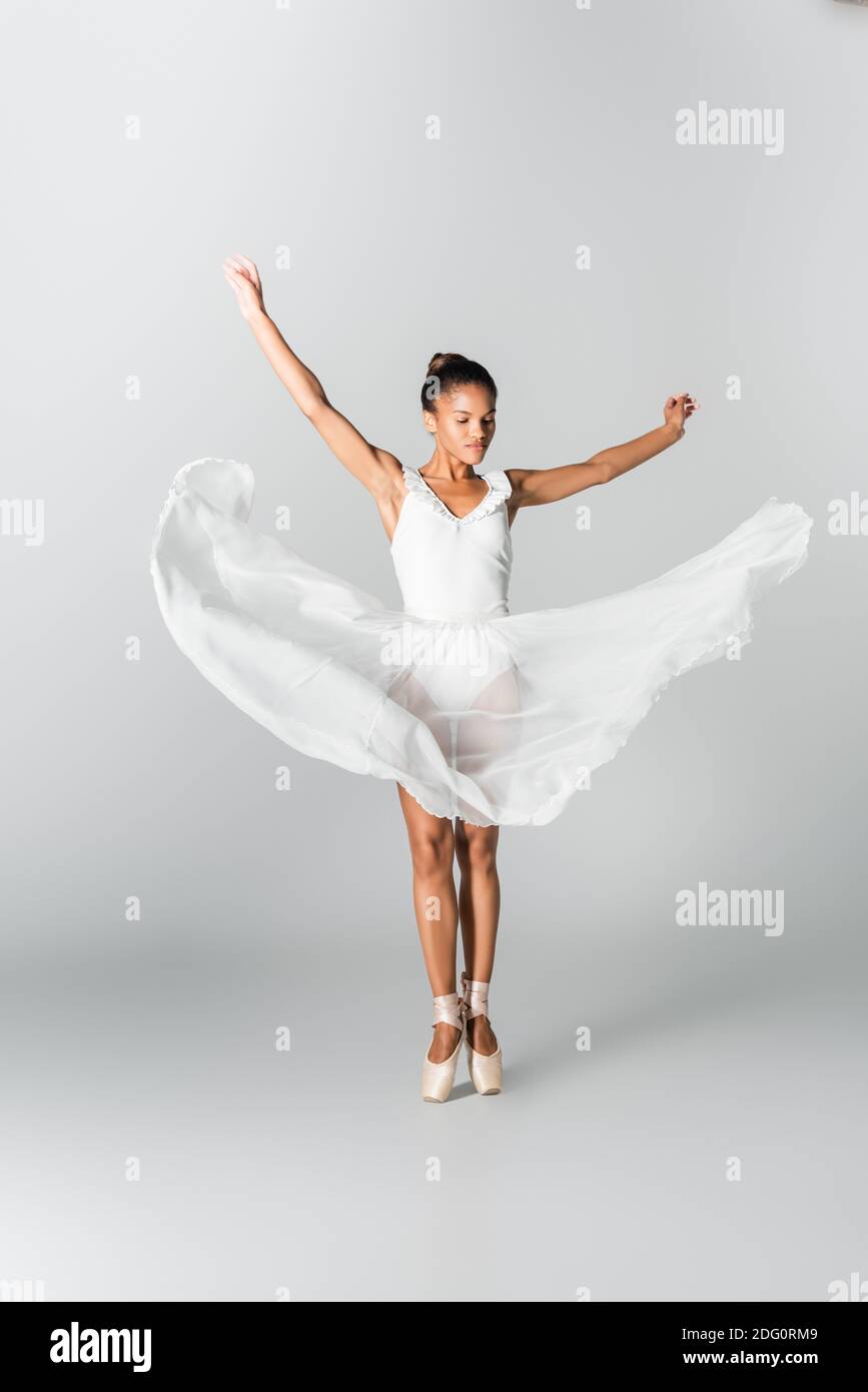 mock spyd tjene graceful african american ballerina in dress dancing on white background  Stock Photo - Alamy