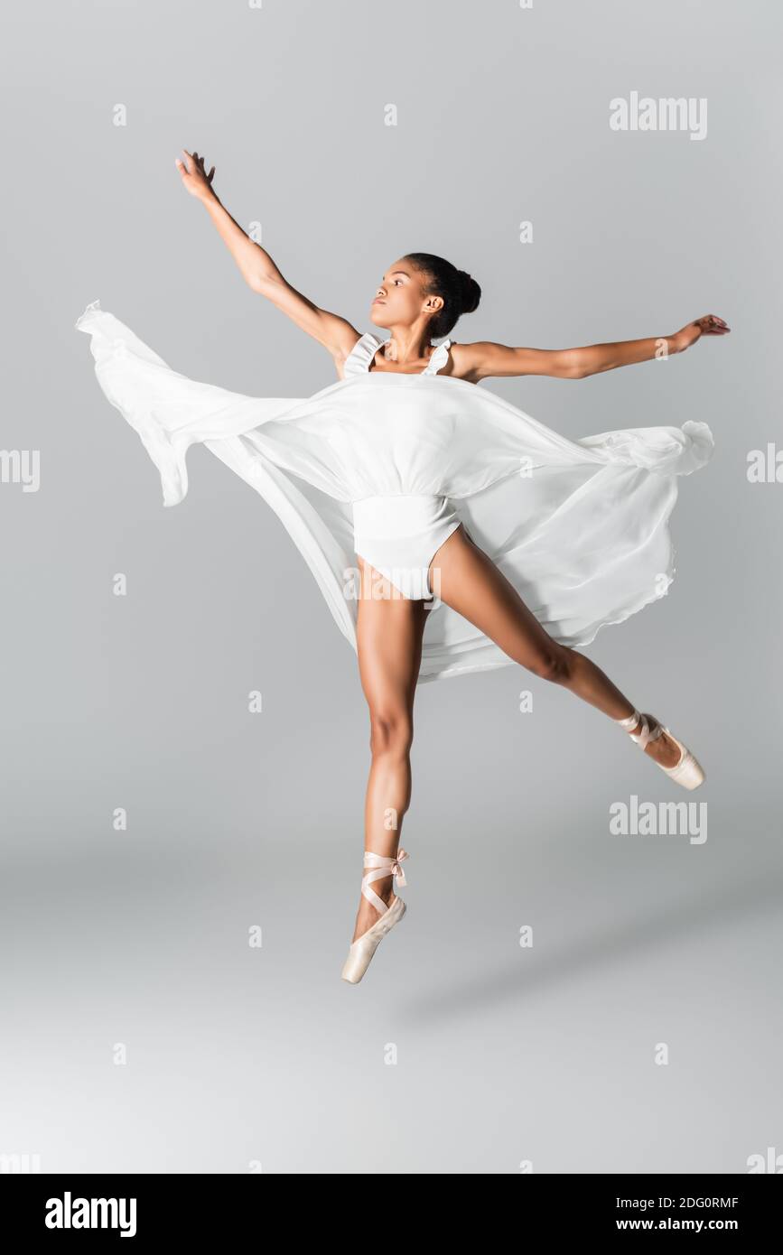 graceful african american ballerina in dress dancing on white background  Stock Photo - Alamy