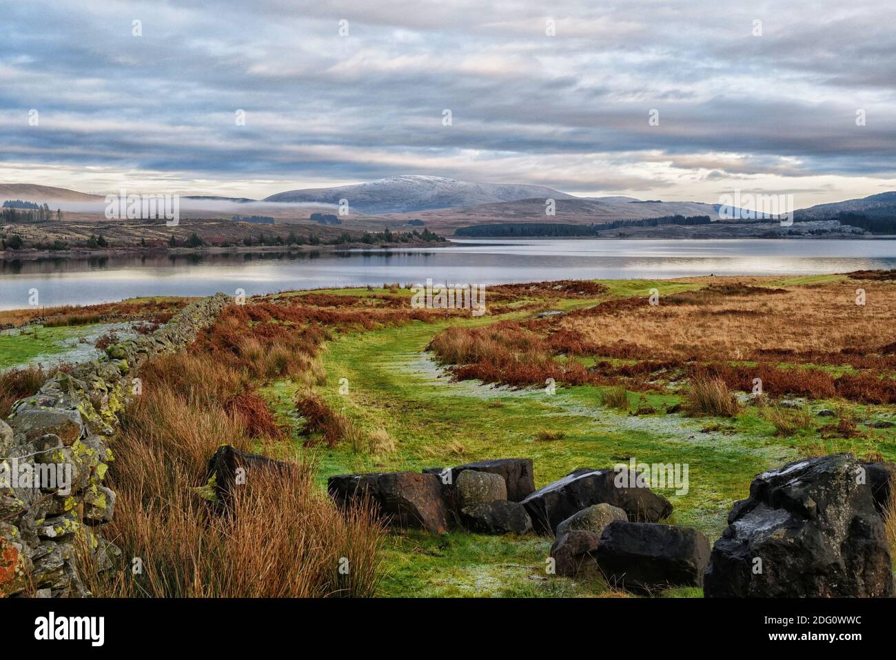 Looking across Loch Doon to the snow capped Benbrack in Dumfries and Galloway Stock Photo