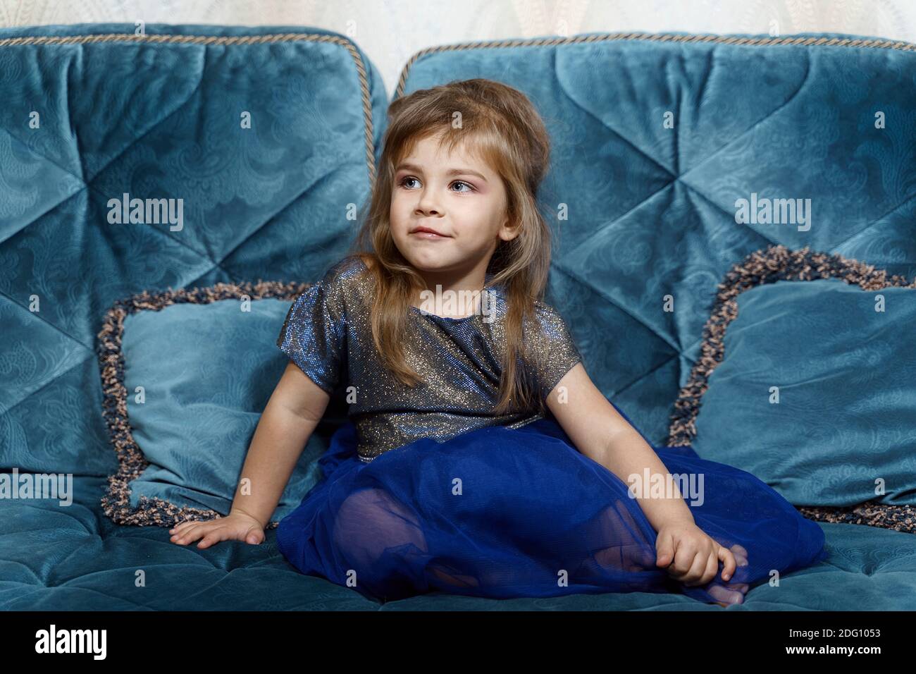 portrait of a beautiful little girl with makeup in a blue dress Stock ...