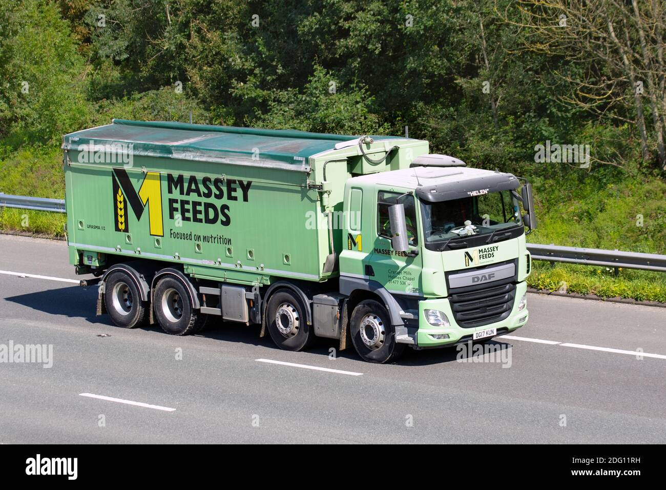 Named vehicle 'Helen' Massey Feeds green Haulage delivery trucks, lorry, transportation, truck, cargo carrier, DAF vehicle,  transport industry, M61 at Manchester, UK Stock Photo