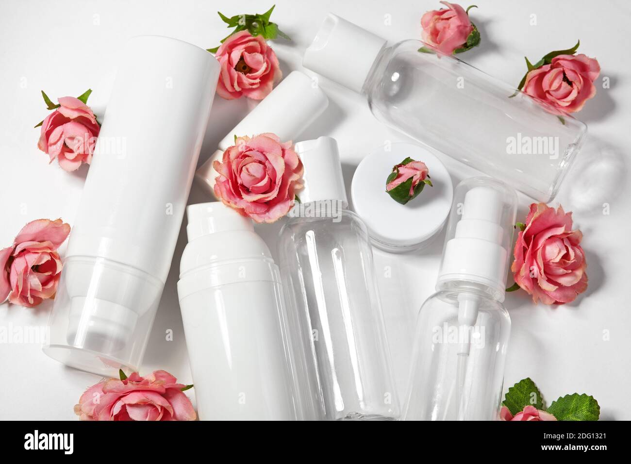 White cosmetic bottles on white background. Wellness, spa and body care bottles collection with spring parfume flowers. Beauty treatment, bathroom set Stock Photo