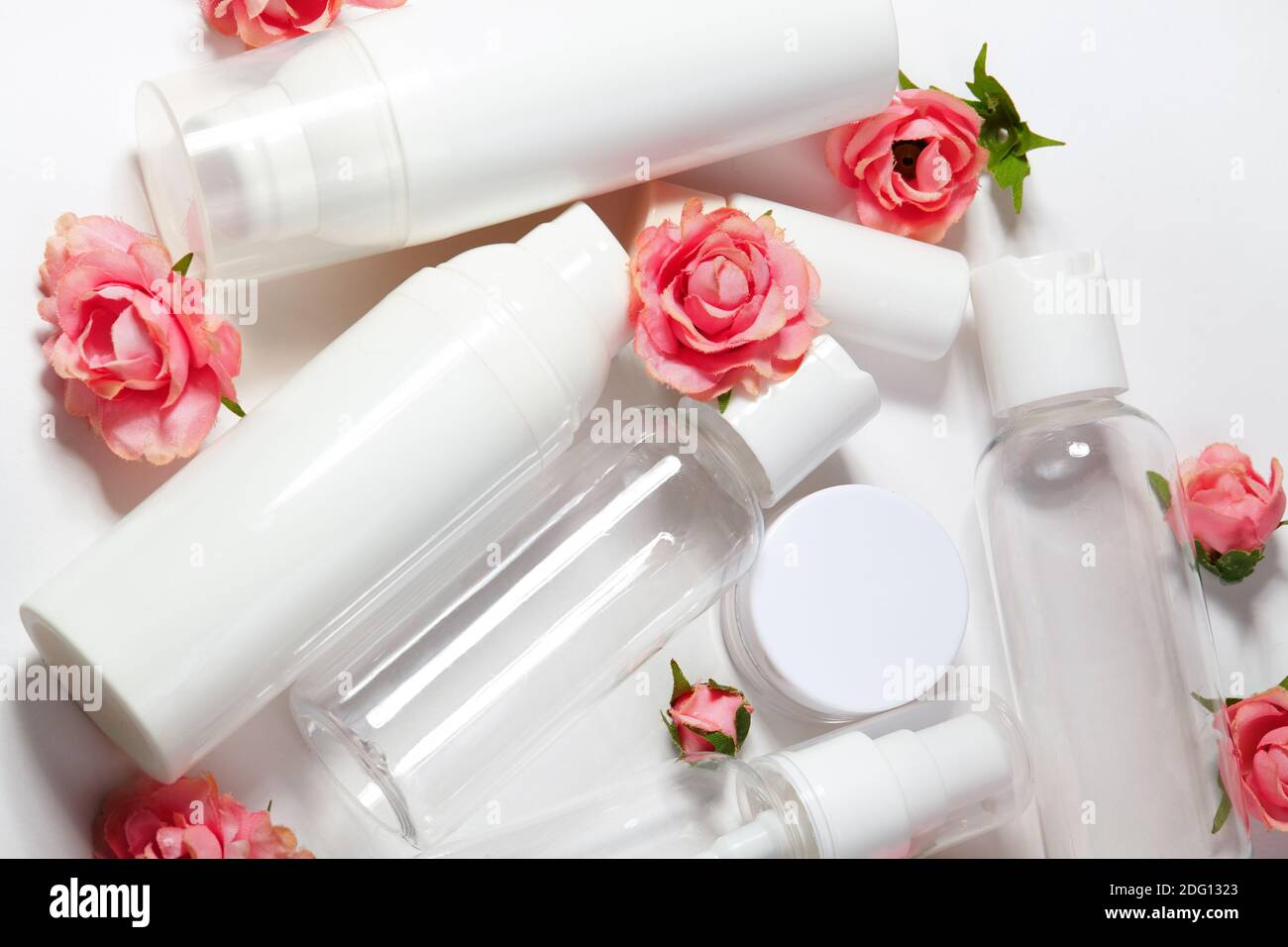 White cosmetic bottles on white background. Wellness, spa and body care bottles collection with spring parfume flowers. Beauty treatment, bathroom set Stock Photo