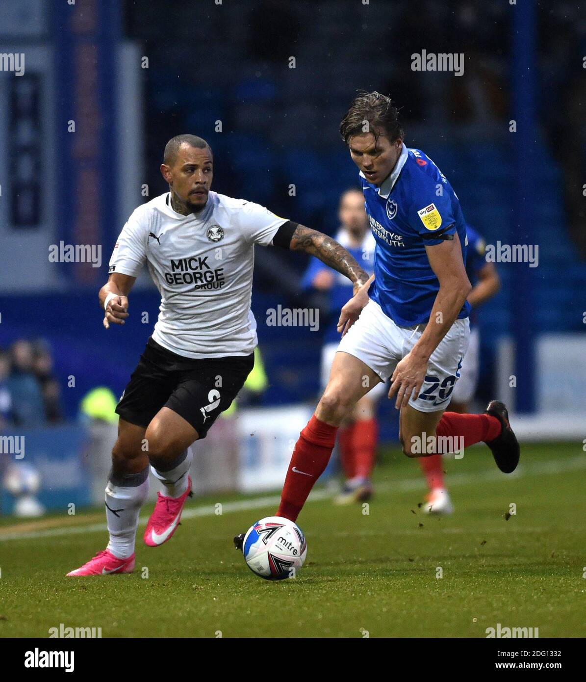 Jonson Clarke-Harris of Peterborough (left) takes on Sean Raggett of Portsmouth during the Sky Bet EFL League One match between Portsmouth and Peterborough United at Fratton Park  , Portsmouth ,  UK - 5th December 2020 - Editorial use only. No merchandising. For Football images FA and Premier League restrictions apply inc. no internet/mobile usage without FAPL license - for details contact Football Dataco Stock Photo